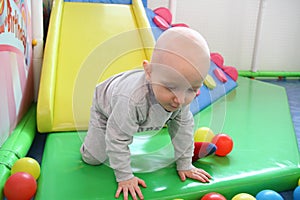 Beautiful baby boy playing at playland