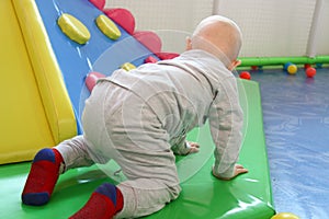 Beautiful baby boy playing at playland