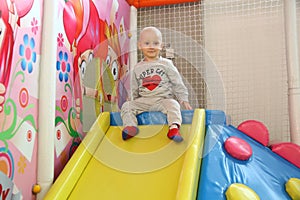 Beautiful baby boy playing at playland