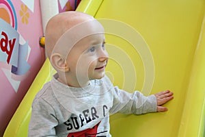 Beautiful baby boy playing at playland