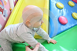 Beautiful baby boy playing at playland