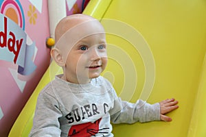 Beautiful baby boy playing at playland