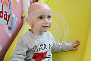 Beautiful baby boy playing at playland