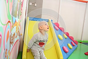 Beautiful baby boy playing at playland