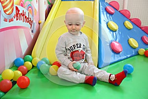 Beautiful baby boy playing at playland