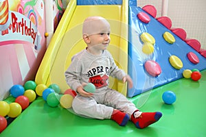 Beautiful baby boy playing at playland