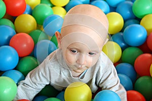 Beautiful baby boy playing at playland