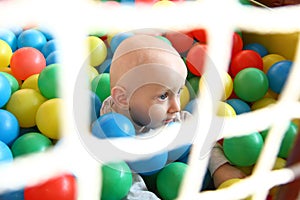 Beautiful baby boy playing at playland