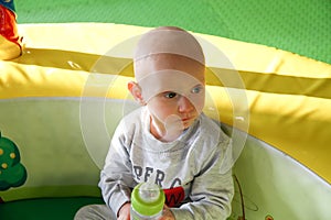 Beautiful baby boy playing at playland