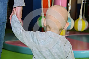 Beautiful baby boy playing at playland