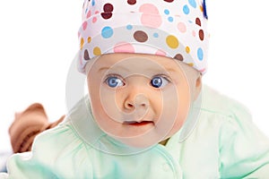 Beautiful baby in the cap. Close-up. Studio photo