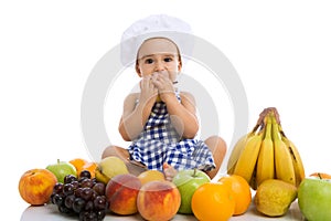 Beautiful baby chef with different fruits