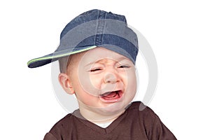 Beautiful baby crying with a cap