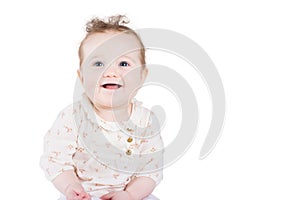 Beautiful baby girl with curly hair in an elegant shirt