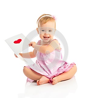 Beautiful baby girl with cute valentine postcard with a red hear