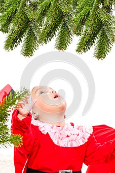 Beautiful baby girl in front of the christmas tree