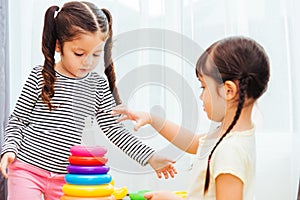 Beautiful baby girl kindergarten playing loop toy education