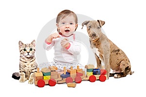 Beautiful baby girl, playing wooden train with a pets