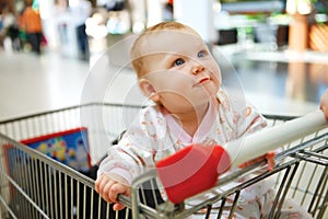 Beautiful baby girl in shopping cart - trolley