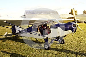 beautiful baby girl sitting in the cockpit of a small two-seater plane