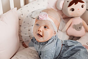 Beautiful baby girl Todler smiles in crib