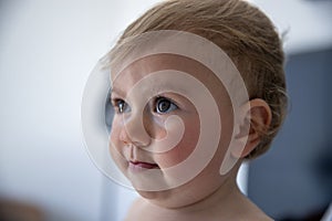 Beautiful baby girl watching television off camera