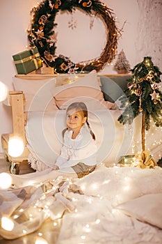 Beautiful baby girls near a Christmas tree with gifts