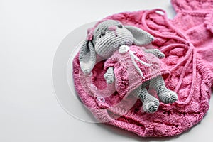 Beautiful baby knitted clothes and a toy for a newborn baby