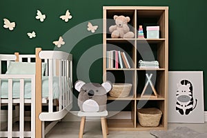 Beautiful baby room interior with stylish furniture and comfortable crib