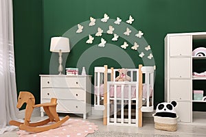 Beautiful baby room interior with furniture and comfortable crib