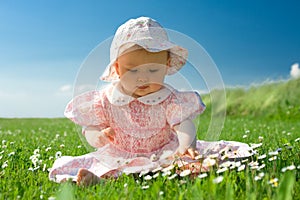 Beautiful baby sat in field photo
