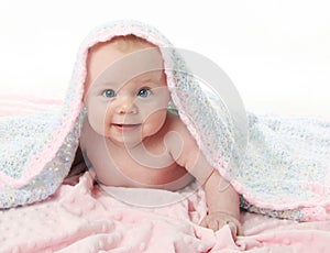 Beautiful baby under a blanket
