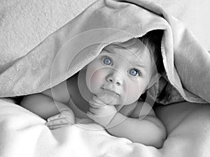 Beautiful baby under blanket