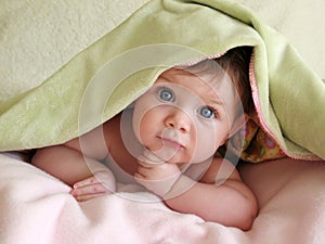 Beautiful baby under blanket
