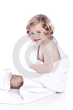 Beautiful baby under a white towel