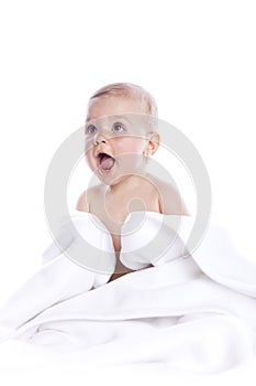 Beautiful baby under a white towel