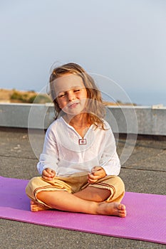Beautiful baby on the yoga mat