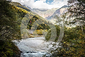 Beautiful background of the center of Kamikochi national park by snow mountains, rocks, and Azusa rivers from hills covered