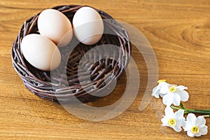 Beautiful background. Eggs in a basket. Wonderful Easter decoration. Homemade products for a healthier life. Spring daffodils.