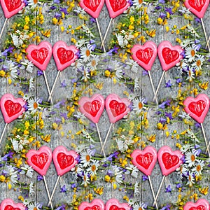 Beautiful background of flowers field of daisies and bells and two hearts made of caramel and marzipan on Valentine`s day. Copy