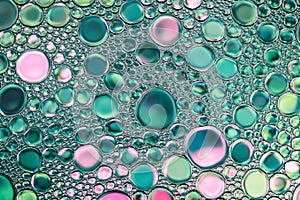 Beautiful background of green and pink water drops.