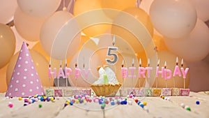 Beautiful background happy birthday number 5 with burning candles, birthday candles pink letters for a five year old child.