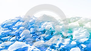 Beautiful background with heap of broken ice blocks outdoors. Wallpaper with ice drift hill. Copy space. Northern