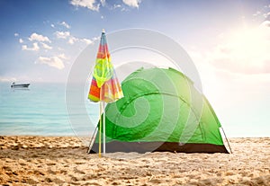 Beautiful background summer concept, tent on beach at sunset