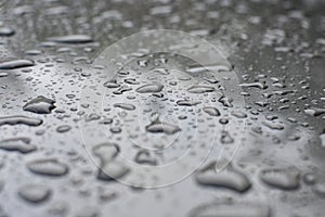 Beautiful background texture of rain water drops on grey black metal surface. Beautiful backgrounds. Drops of water on a