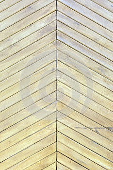 Beautiful background with a texture of thin wooden boards. A wall of pale yellow diagonal slats.