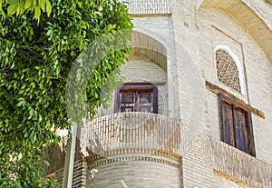 Beautiful balcony with an ancient wooden door in MEMORIAL COMPLEX of KHOJA BAHAUDDIN NAKSHBAND, Bukhara, Uzbekistan