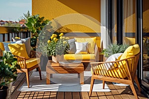 Beautiful balcony with comfortable chairs, wooden table and many green potted flowers plants. Bold relaxing area at home