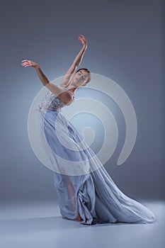 The beautiful ballerina dancing in blue long dress