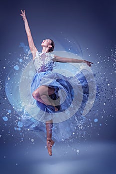 The beautiful ballerina dancing in blue long dress